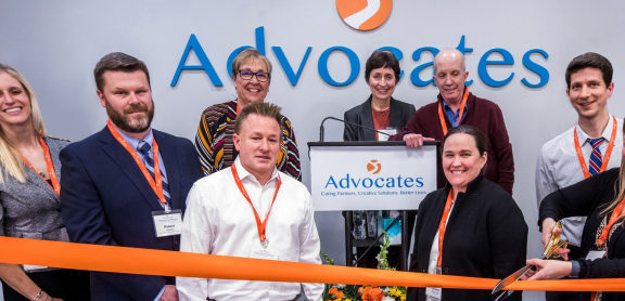 Cover of Annual Report featuring photo of ribbon cutting at Community Behavioral Health Center grand opening.