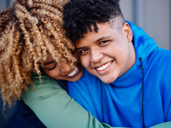 two people hugging and smiling